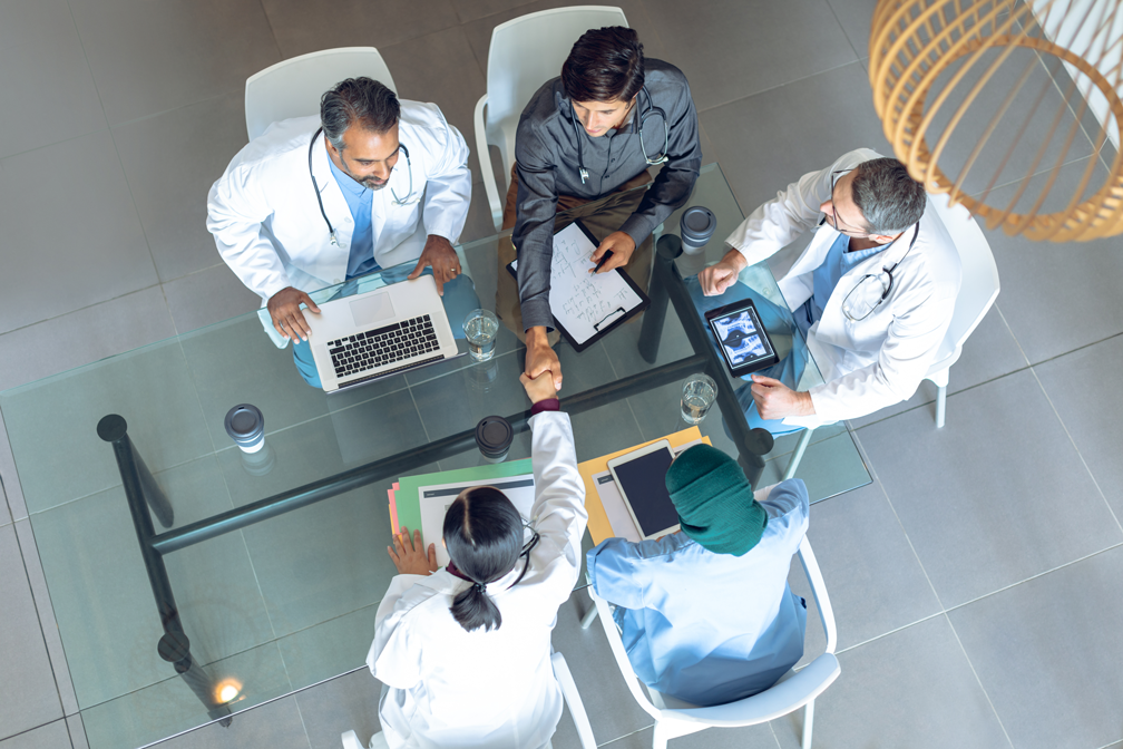 providers discussing healthcare financial strategies at table overhead view